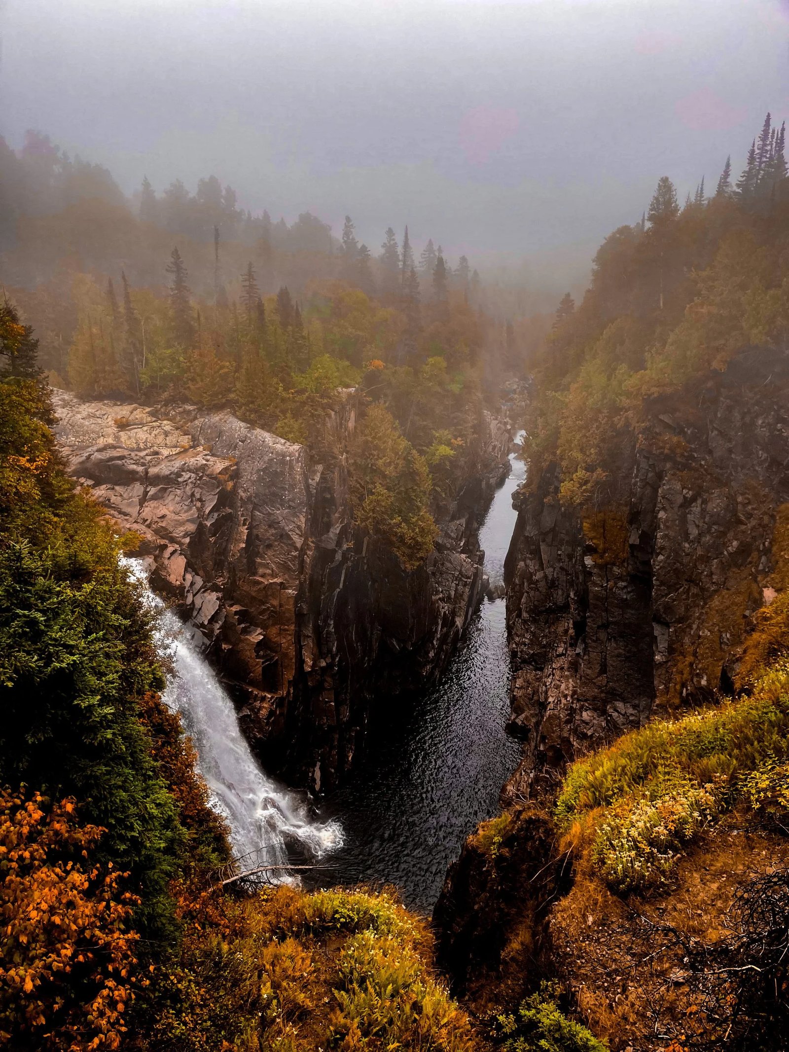 Aguasabon Falls dropping into the misty gorge.