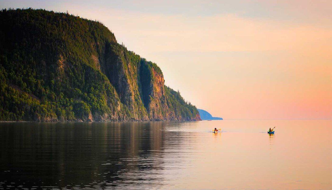 Kayakers below the cliffs at Old Woman Bay, Lake Superior.